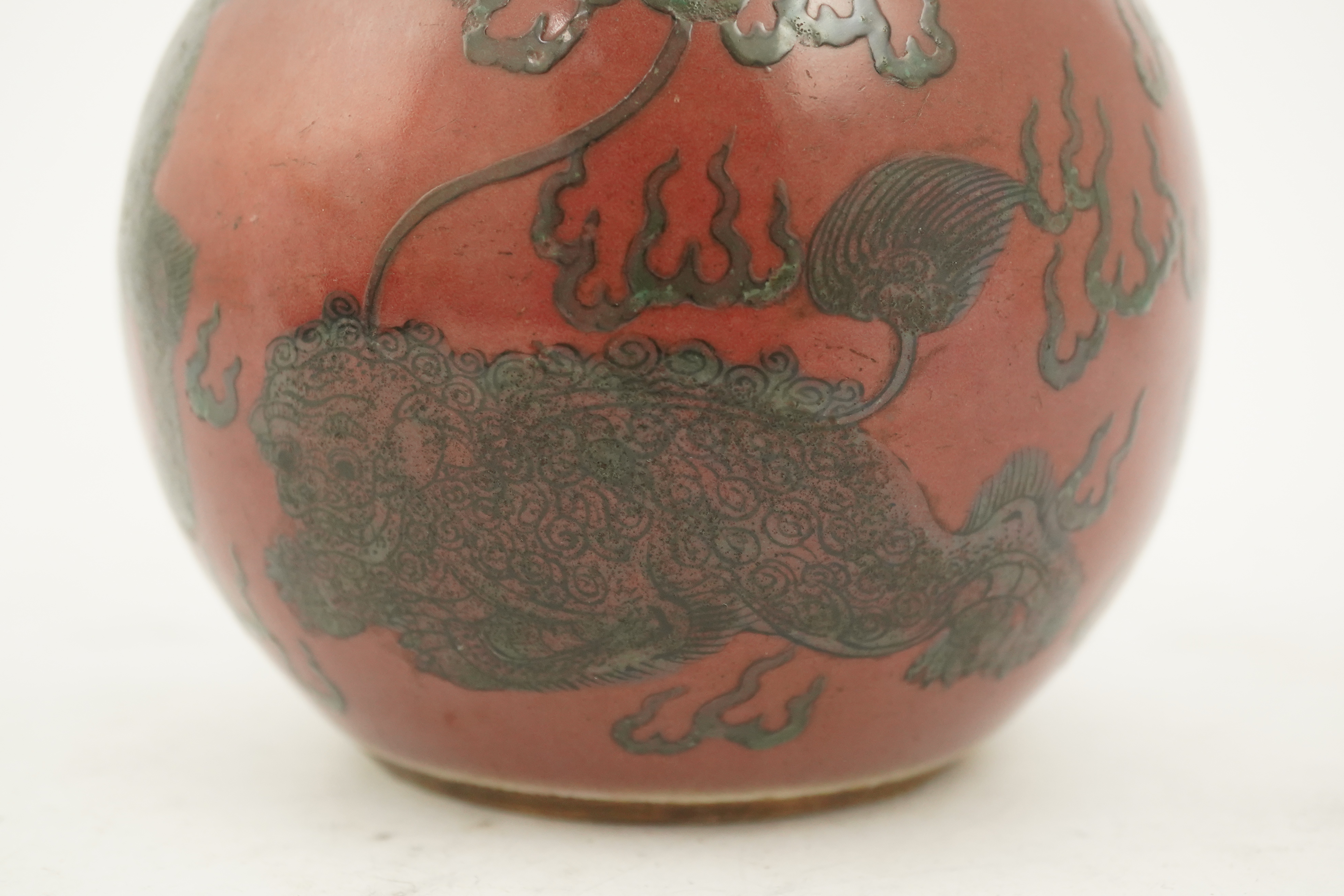 A Chinese green enamelled sang de boeuf ground 'lion' bottle vase, probably 18th century